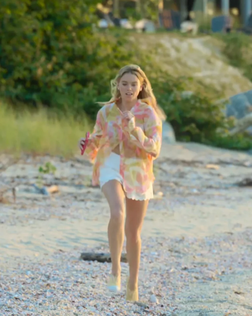 Simone DeWitt (played by Milly Alcock) on Sirens on Netflix was spotted wearing this orange printed button down shirt on Sirens on episode 'Exile' (1x01) in May 2025. Simone's Top is the Benson Abstract Button-Front Shirt by Generation Love . Simone's Shorts is the Scalloped Shorts by Aqua.